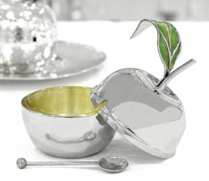 An apple-shaped silver honey dish with an enamel decoration